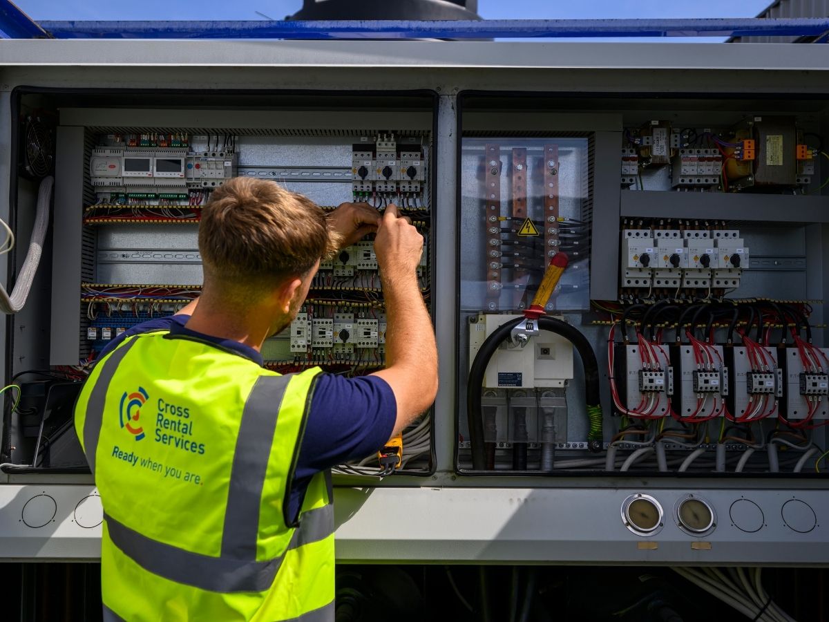 CRS engineer working on electrical controls during temporary HVAC installation