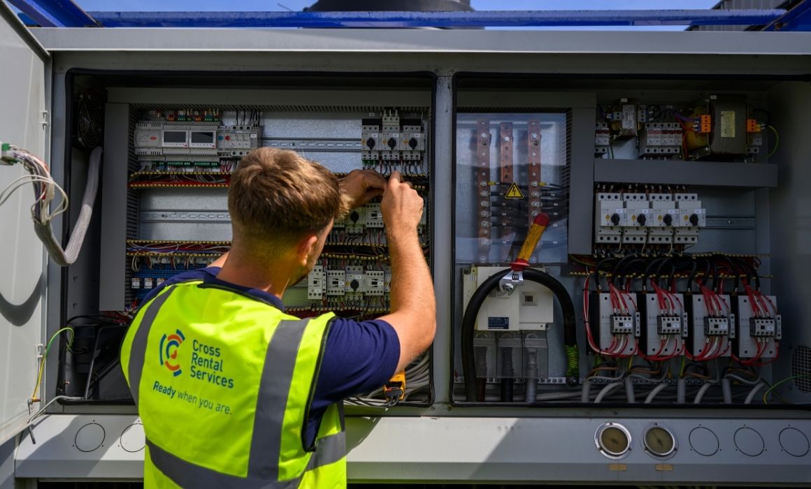 CRS engineer working on electrical controls during temporary HVAC installation