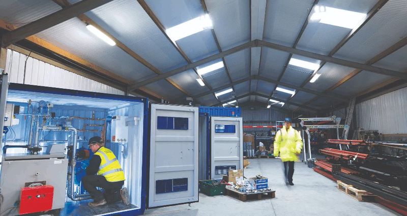 Technicians assembling commercial boilers in the heating and cooling fabrication warehouse in Andover, UK